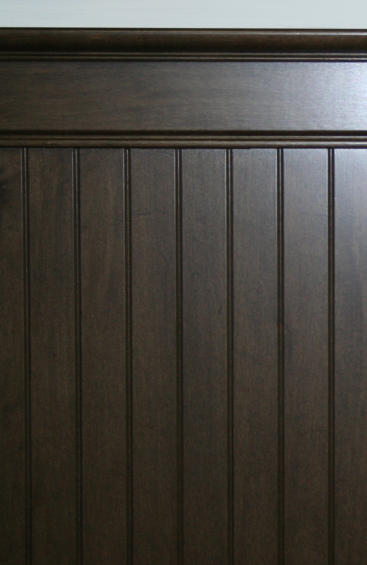 A close up look at interior beadboard made up of stained maple hardwood