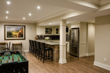 Basement kitchen area showing a square MDF recessed panel column wrap beside the slab, constructed from unprimed MDF and designed for interior architectural detailing.