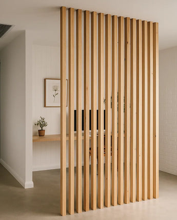 Wooden slat room divider in a modern interior setting. The vertical hardwood pieces create a stylish visual barrier between rooms.