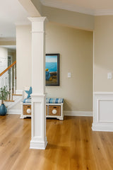 Home interior with a square half recessed MDF column wrap, designed with a 7 5/8-inch shaft width and on-site assembly.