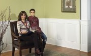 Photo of family in front of raised panelled wainscoting in living room